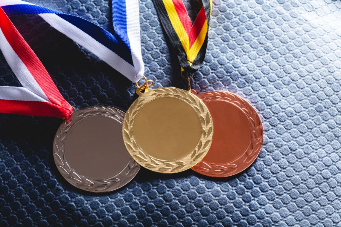 Gold Silver and Bronze Medal on Velvet Cushion Credits Photocreo Canva